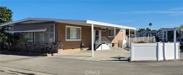 a view of a house with floor to ceiling windows and a basket ball poll