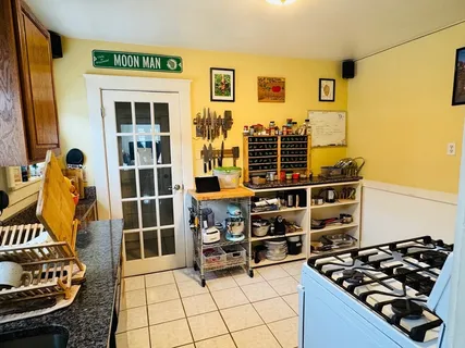 a kitchen with stainless steel appliances granite countertop a stove and a wooden cabinets