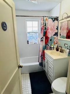 a bathroom with a sink toilet and shower