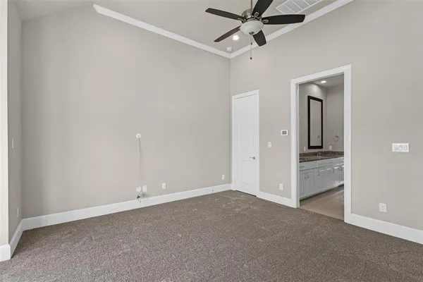 an empty room with closet and a chandelier fan
