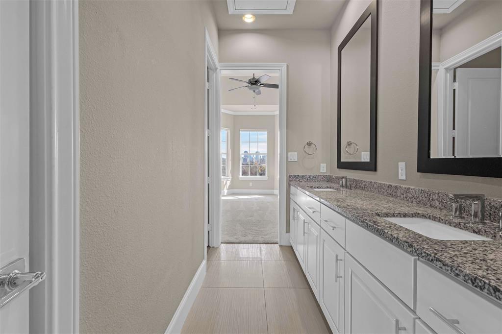 2238 Alterbrook Lane Dallas, TX 75219 - Photo 13 of 19 a bathroom with a granite countertop sink and a mirror