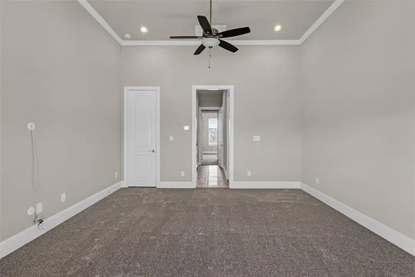 an empty room with fan and windows