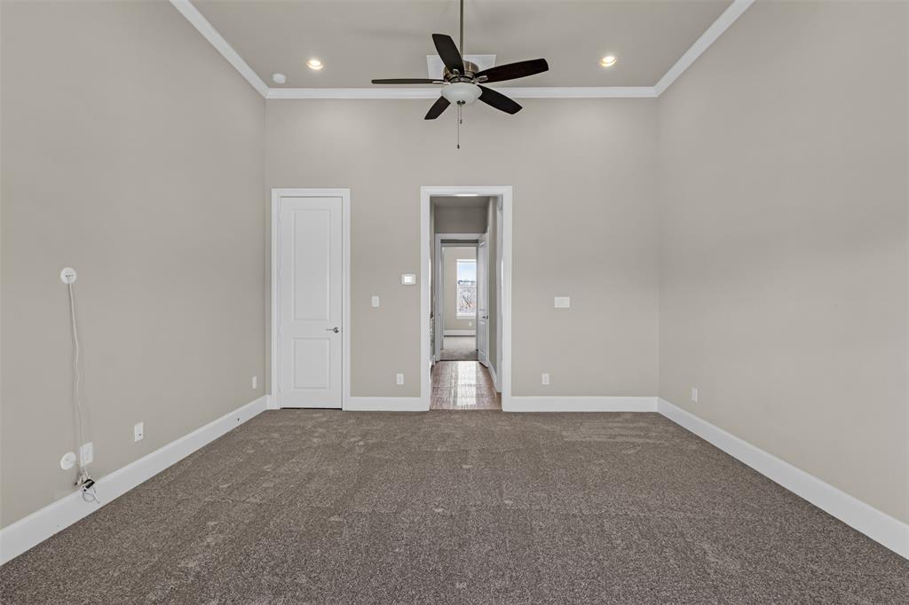 2238 Alterbrook Lane Dallas, TX 75219 - Photo 16 of 19 an empty room with fan and windows