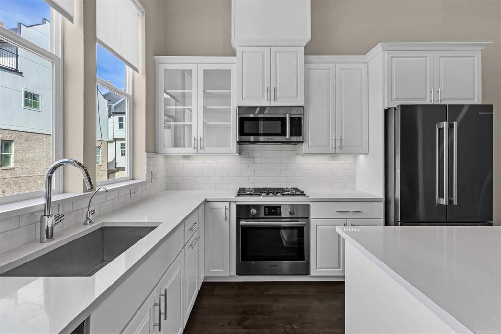 2238 Alterbrook Lane Dallas, TX 75219 - Photo 5 of 19 a kitchen with stainless steel appliances granite countertop a stove a sink and a refrigerator