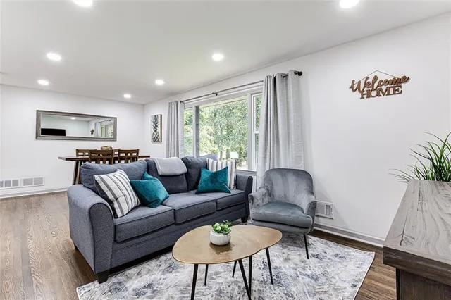 a living room with furniture and a large window