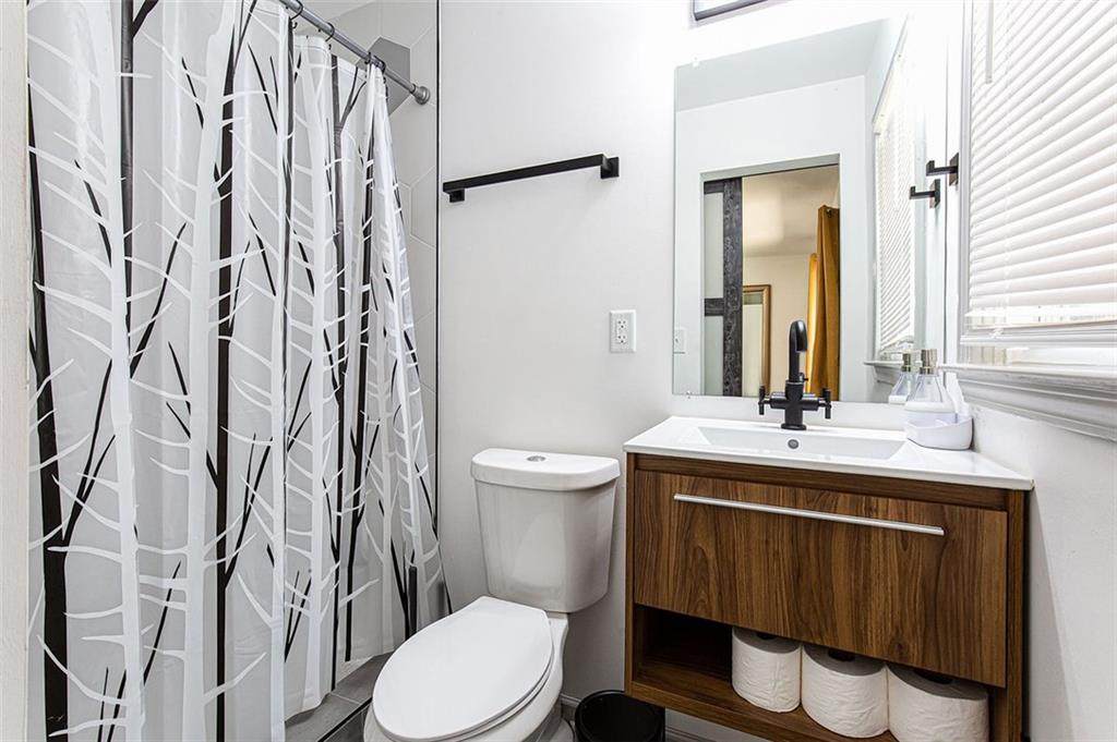 1300 Wichita Drive Southwest Atlanta, GA 30311 - Photo 6 of 10 a bathroom with a toilet a sink and a mirror