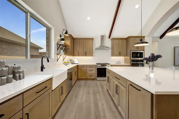 a kitchen with a sink stove and cabinets