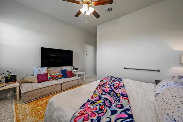 a bedroom with a bed and a window