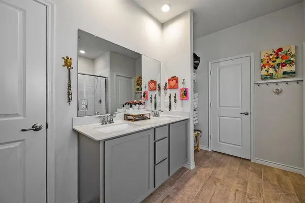 a spacious bathroom with a tub sink and mirror