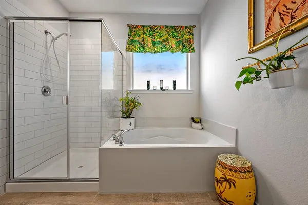 a bathroom with a tub sink and mirror