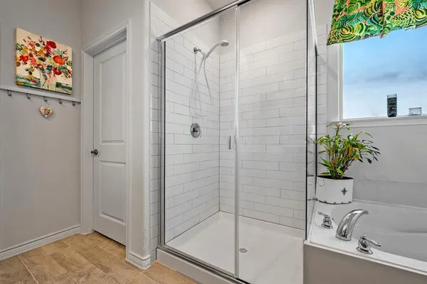 a bathroom with a tub and a shower