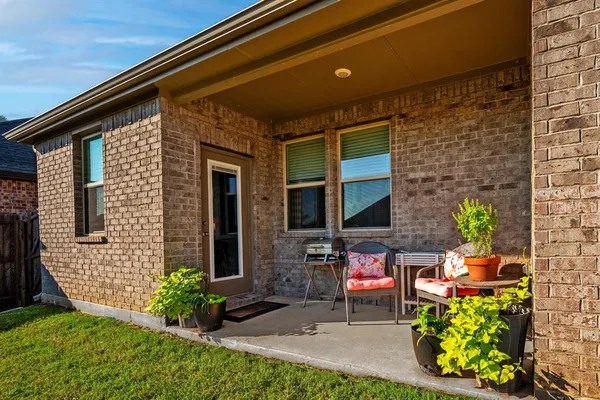 a view of a two chairs in the patio