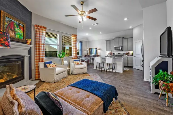 a living room with furniture fireplace and flat screen tv