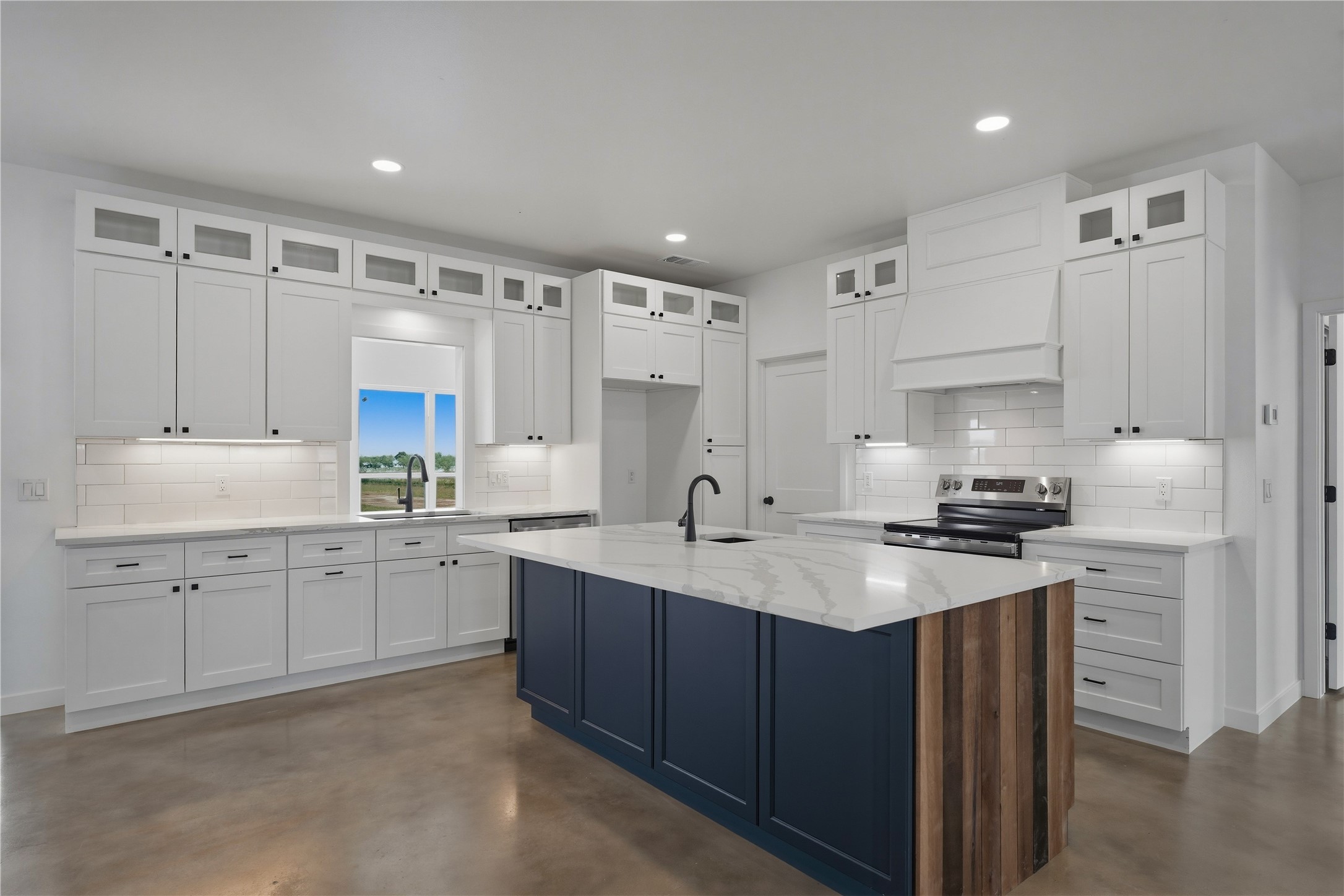 9391 Hajovsky Road La Grange, TX 78945 - Photo 2 of 22 a kitchen with white cabinets sink and stove