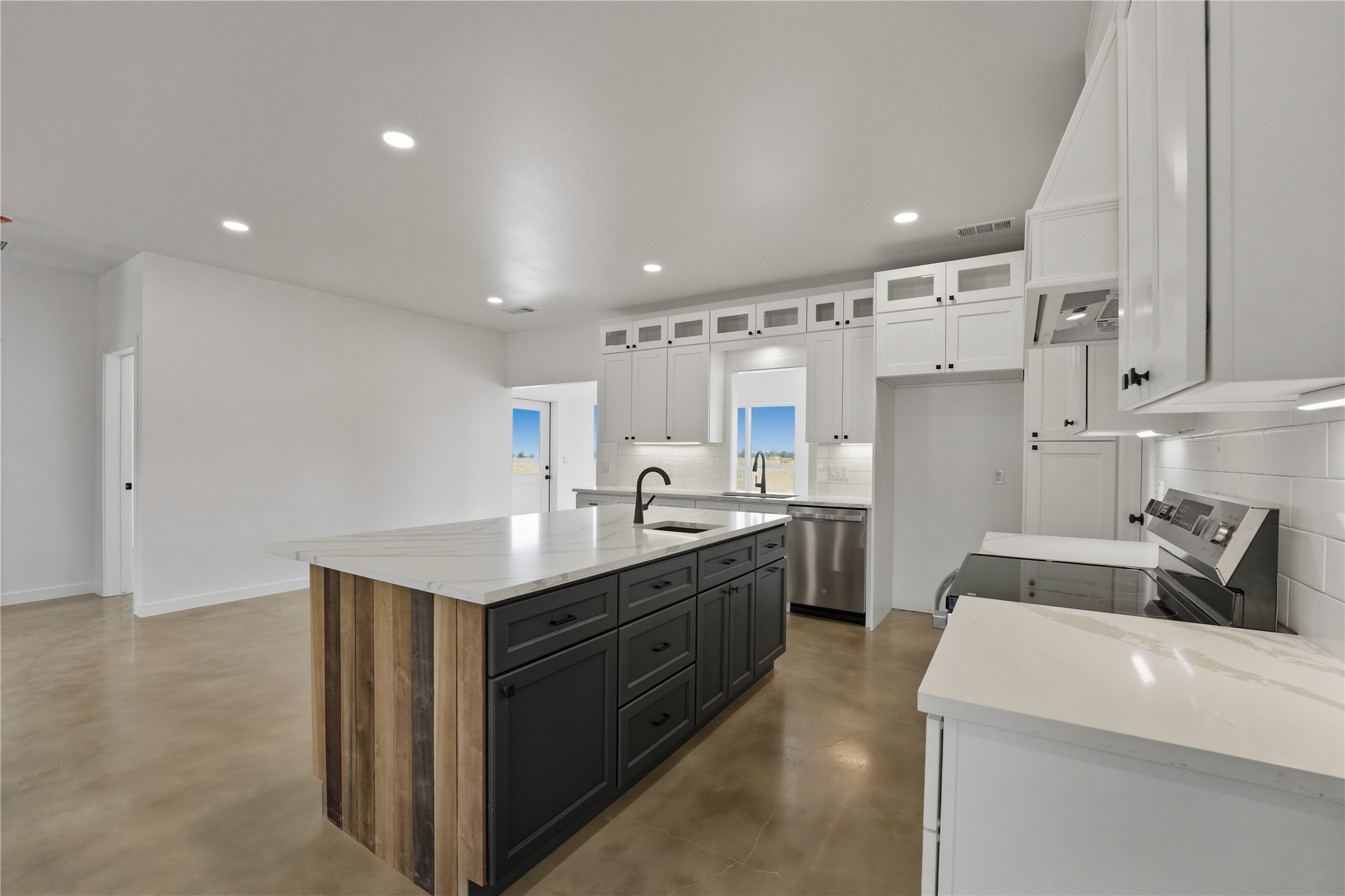 9391 Hajovsky Road La Grange, TX 78945 - Photo 3 of 22 a kitchen with stainless steel appliances granite countertop a sink stove and refrigerator