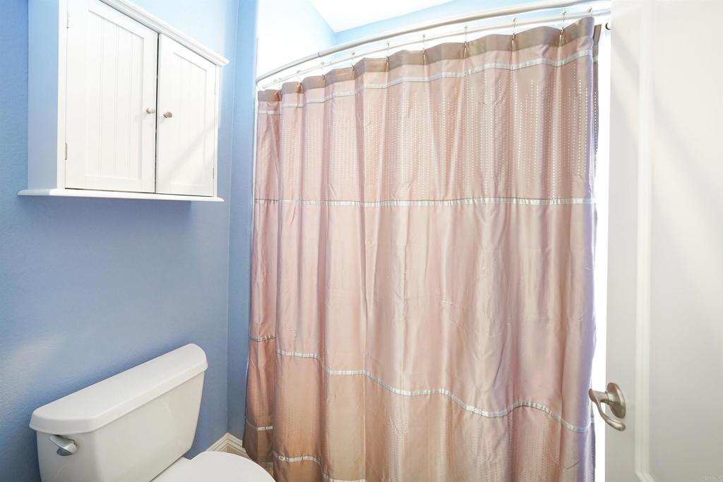 22963 Stokes Road Ramona, CA 92065 - Photo 43 of 57 a bathroom with a toilet and a window
