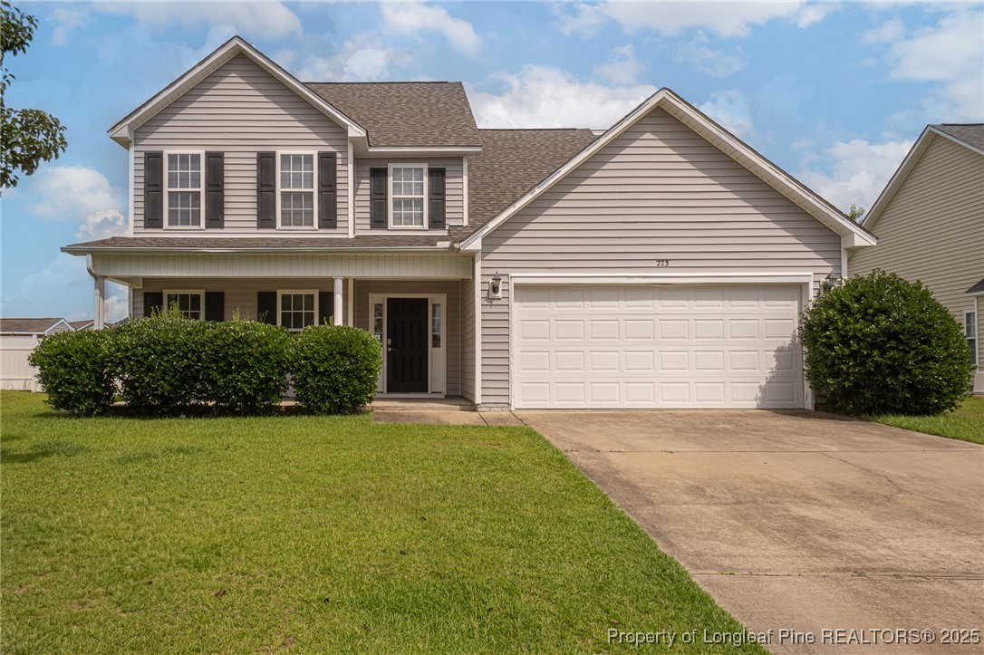 a front view of a house with a yard and garage