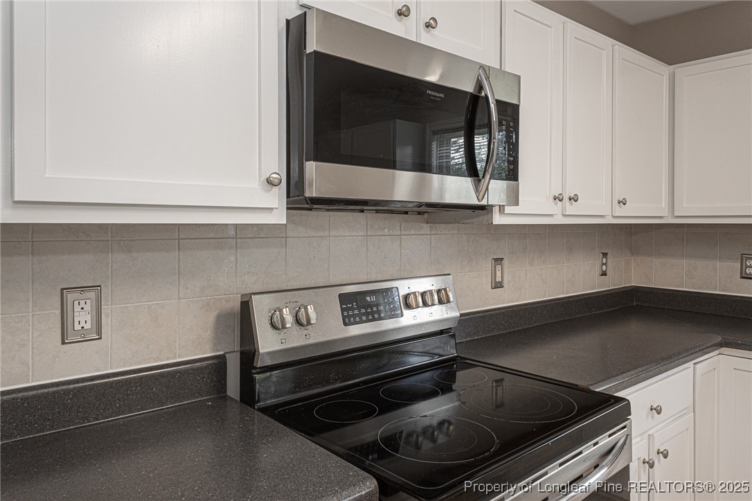 273 St George Drive Raeford, NC 28376 - Photo 12 of 38 a kitchen with a stove and a microwave