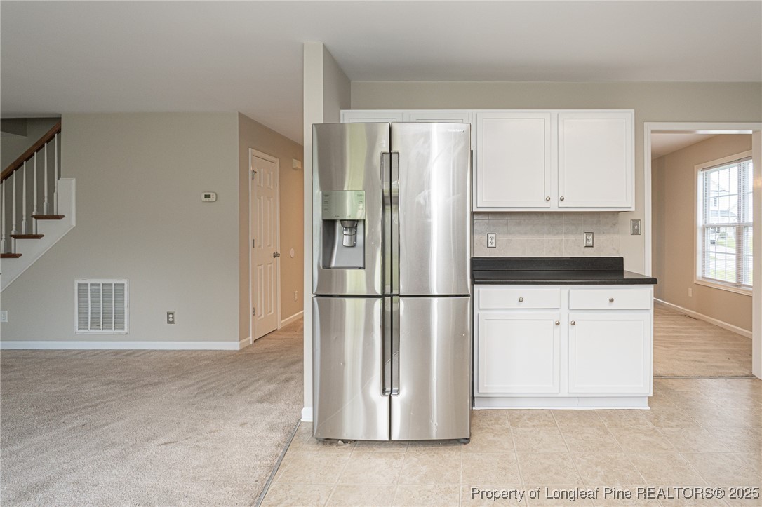 273 St George Drive Raeford, NC 28376 - Photo 13 of 38 a kitchen with white cabinets and refrigerator