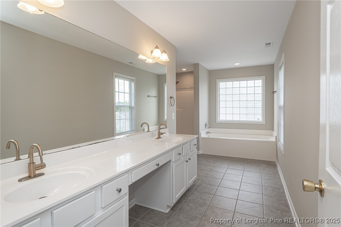 273 St George Drive Raeford, NC 28376 - Photo 21 of 38 a bathroom with a tub sink and mirror