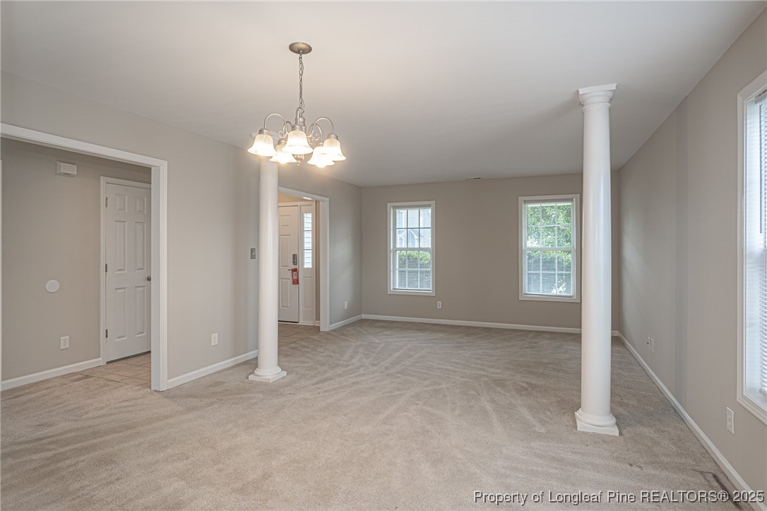 273 St George Drive Raeford, NC 28376 - Photo 7 of 38 an empty room with windows and chandelier