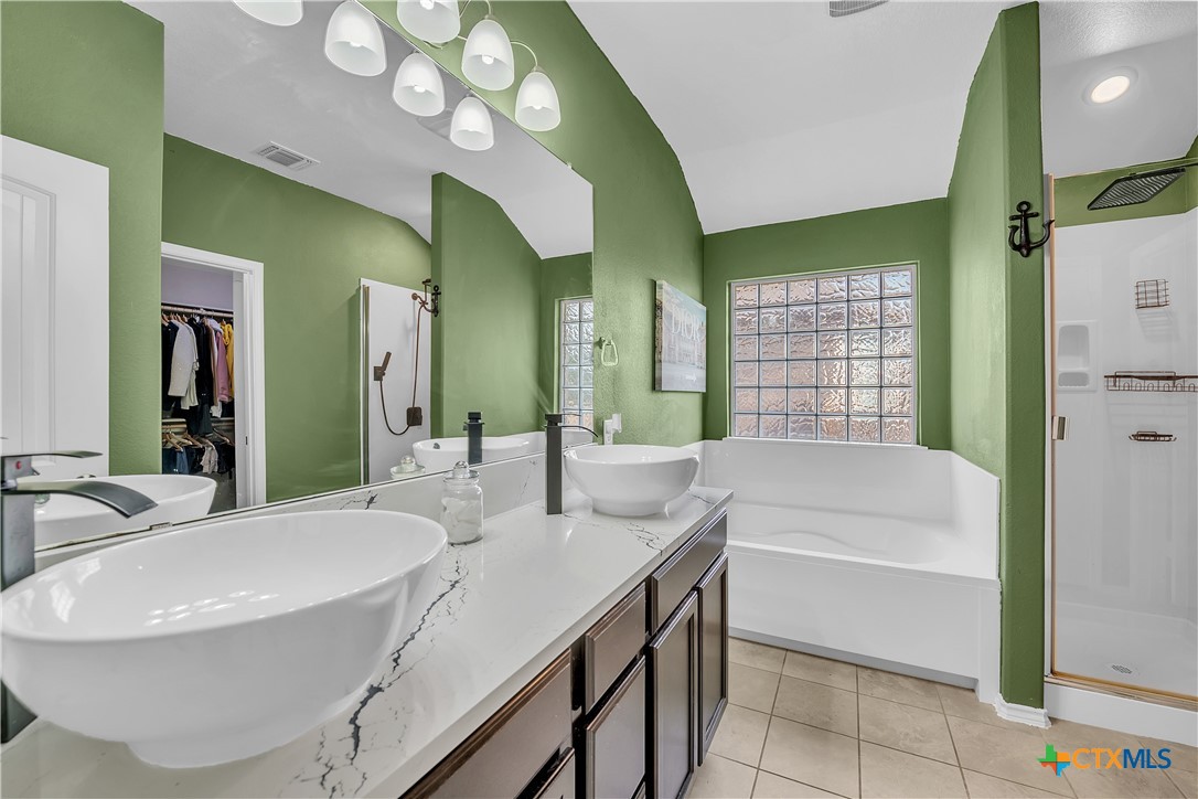 5577 Perdita Drive Belton, TX 76513 - Photo 15 of 25 a bathroom with a bathtub sink and mirror
