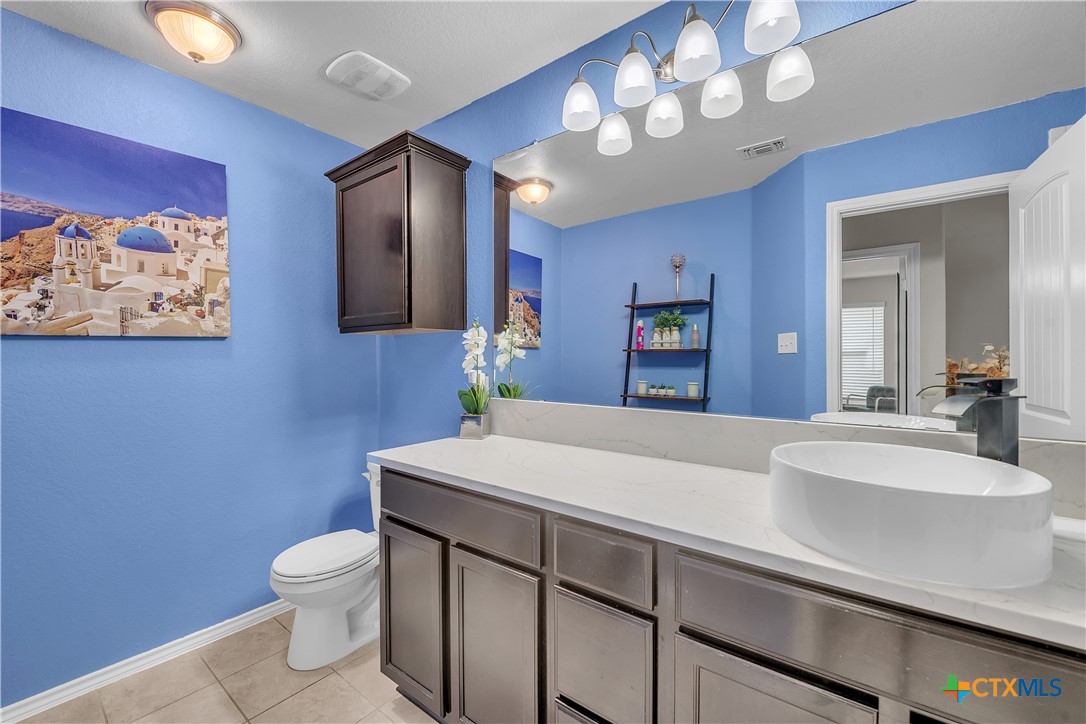 5577 Perdita Drive Belton, TX 76513 - Photo 23 of 25 a bathroom with a sink a toilet and mirror