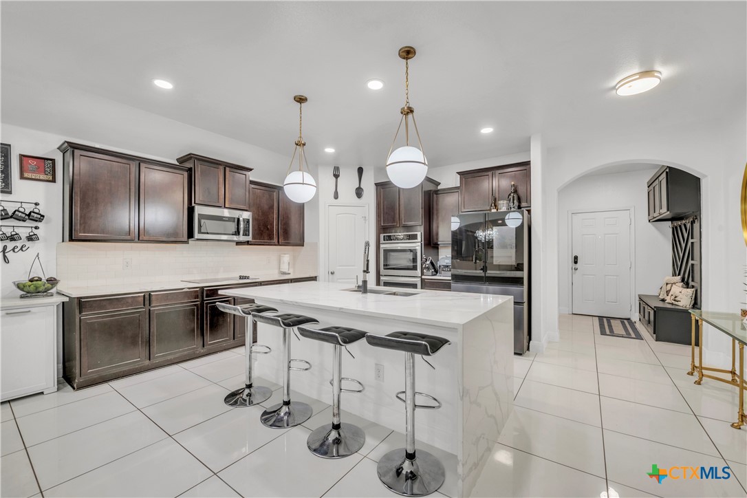 5577 Perdita Drive Belton, TX 76513 - Photo 7 of 25 a kitchen with stainless steel appliances kitchen island granite countertop a sink and cabinets