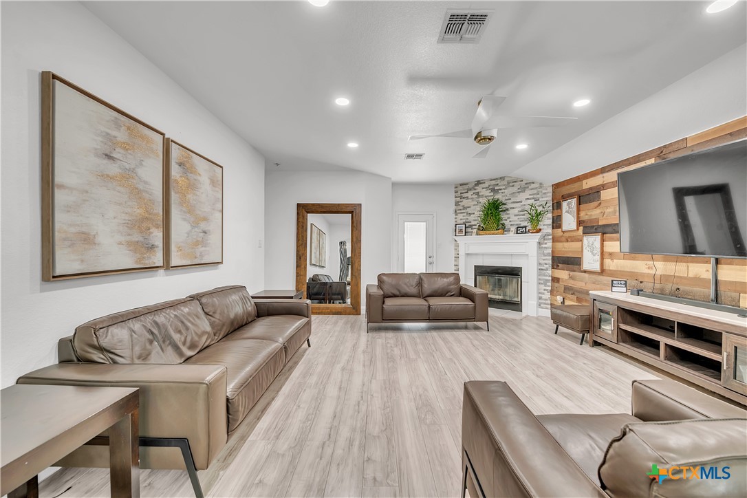 5577 Perdita Drive Belton, TX 76513 - Photo 9 of 25 a living room with furniture fireplace and a flat screen tv