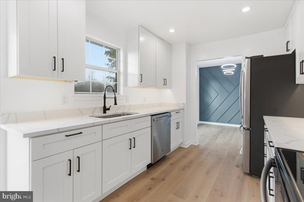 9409 Silver Fox Turn Clinton, MD 20735 - Photo 11 of 33 a spacious bathroom with a double vanity sink and mirror