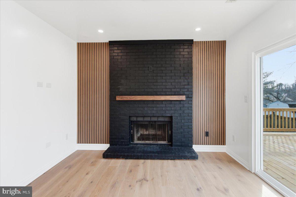 9409 Silver Fox Turn Clinton, MD 20735 - Photo 13 of 33 a living room with a fireplace and a wooden floor