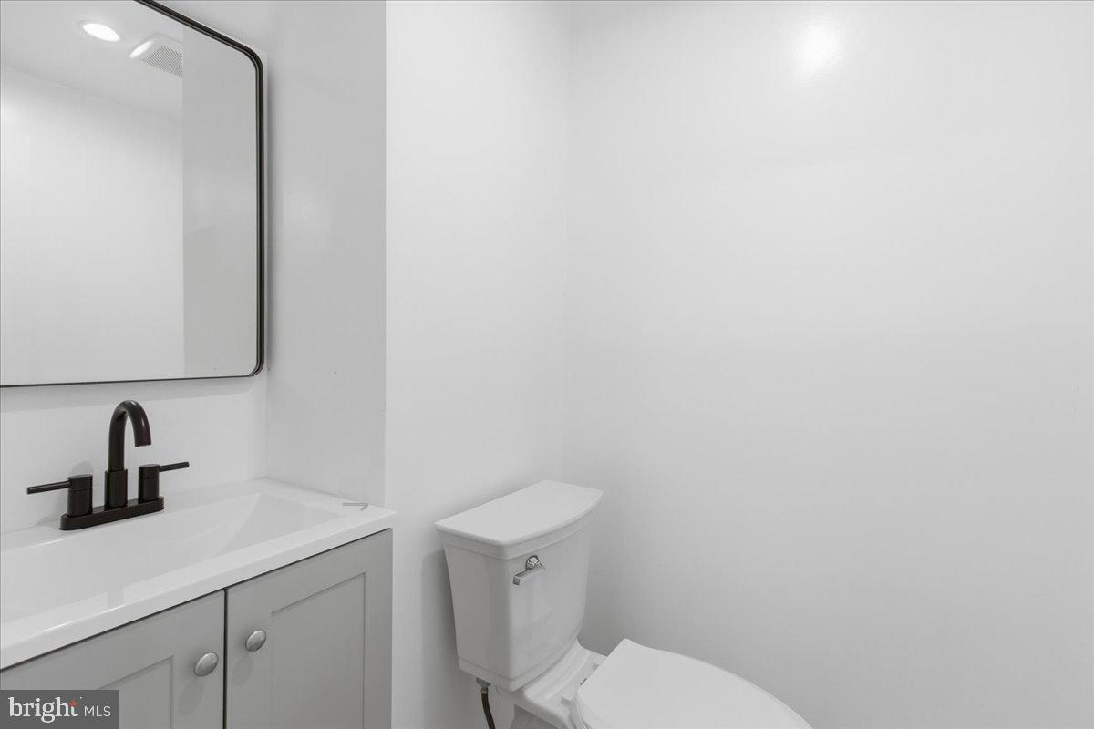 9409 Silver Fox Turn Clinton, MD 20735 - Photo 15 of 33 a bathroom with a toilet sink and mirror