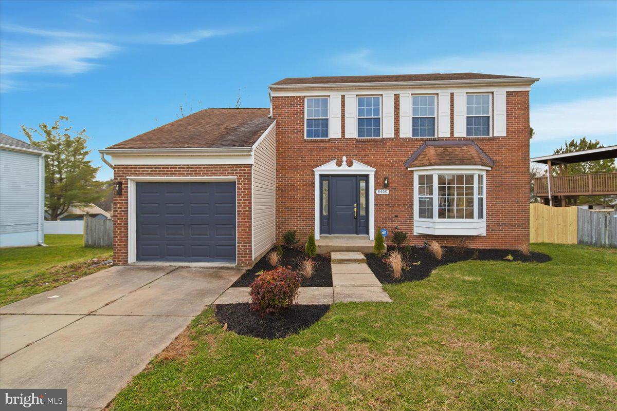 9409 Silver Fox Turn Clinton, MD 20735 - Photo 4 of 33 a front view of a house with a yard and garage