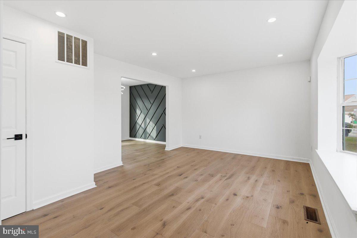 9409 Silver Fox Turn Clinton, MD 20735 - Photo 5 of 33 an empty room with wooden floor and windows