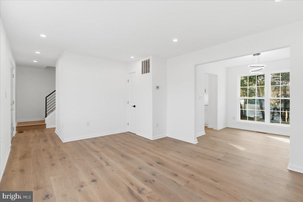 9409 Silver Fox Turn Clinton, MD 20735 - Photo 8 of 33 a view of empty room with wooden floor and windows
