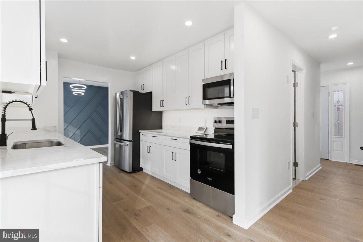 9409 Silver Fox Turn Clinton, MD 20735 - Photo 10 of 33 a kitchen with refrigerator and cabinets