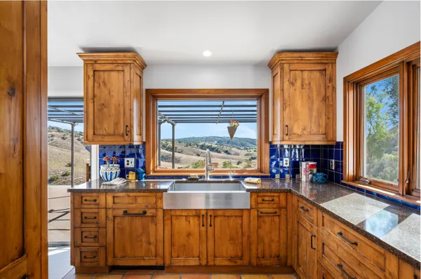 a kitchen with stainless steel appliances granite countertop a stove and a sink