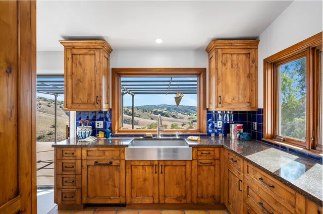 a kitchen with stainless steel appliances granite countertop a stove and a sink
