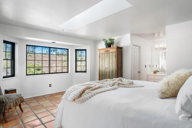 a bedroom with a large bed and a large window