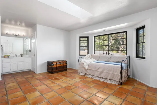 a spacious bedroom with a bed and a window