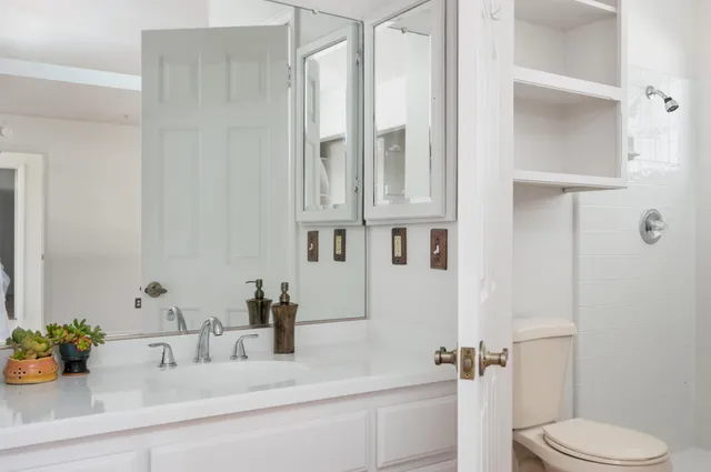 a bathroom with a sink vanity and mirror