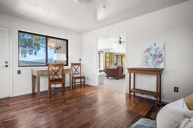 a living room with furniture large window and a chandelier