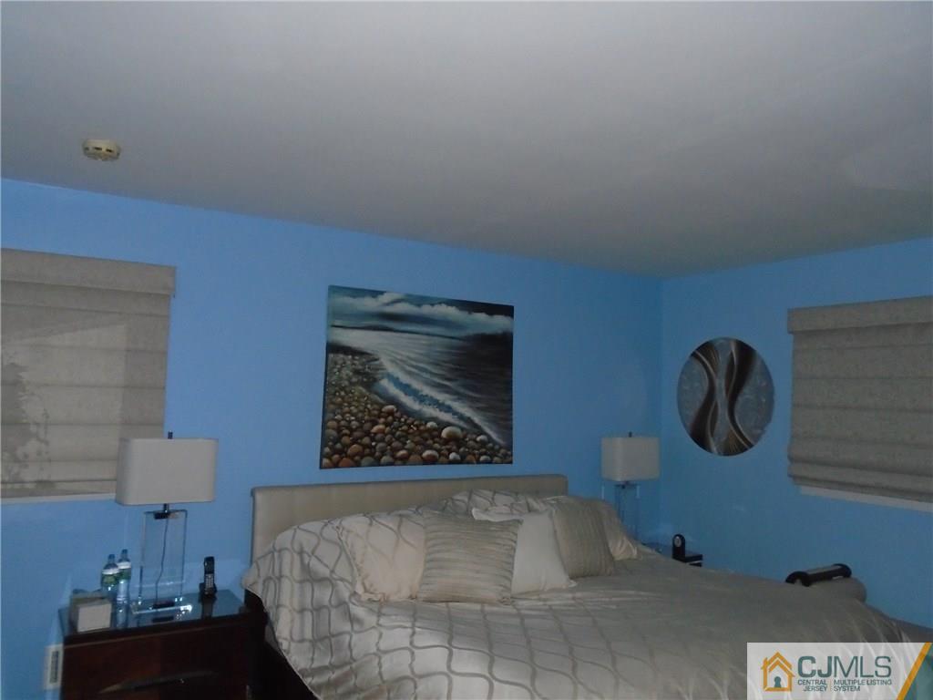 69 Harmon Road Edison, NJ 08837 - Photo 11 of 23 a bedroom with a bed and painting on the wall