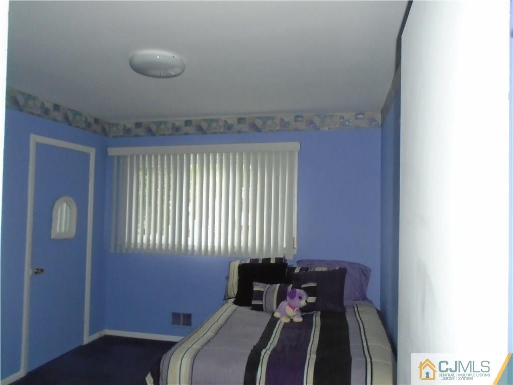 69 Harmon Road Edison, NJ 08837 - Photo 14 of 23 a bed room with a bed and a window
