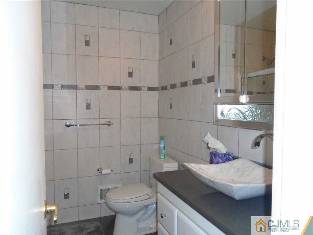 69 Harmon Road Edison, NJ 08837 - Photo 16 of 23 a bathroom with a sink and toilet