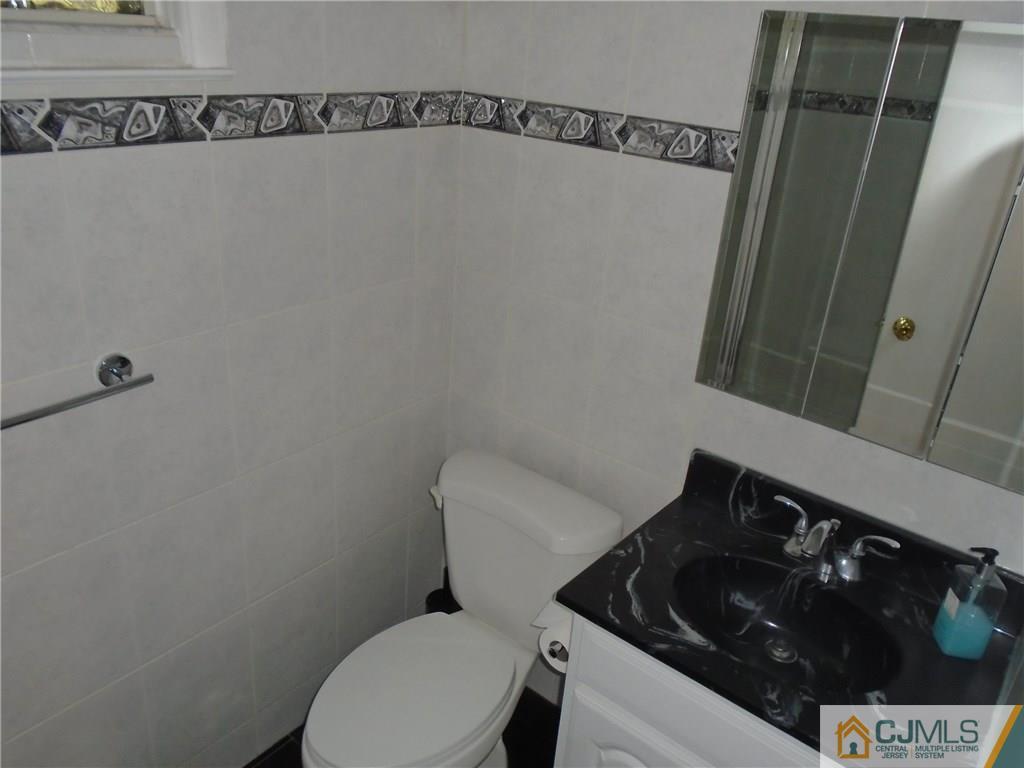 69 Harmon Road Edison, NJ 08837 - Photo 18 of 23 a bathroom with a toilet and a sink