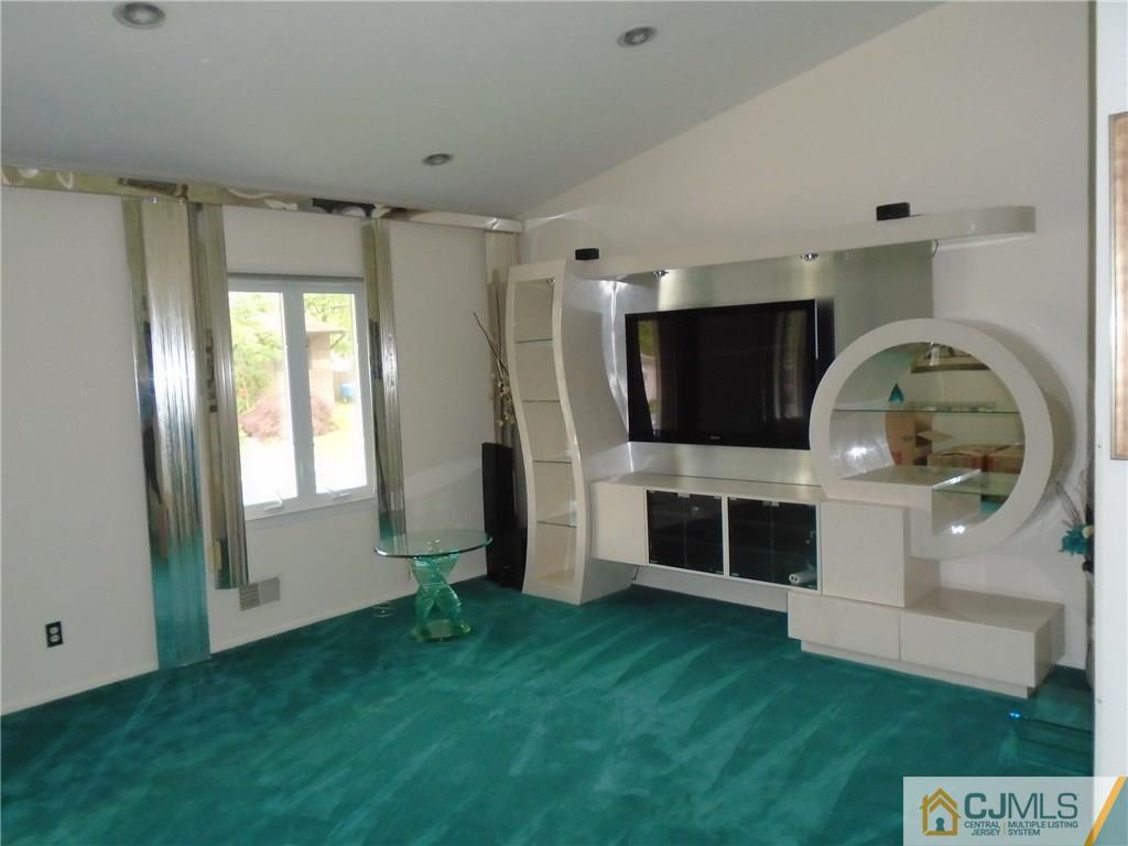 69 Harmon Road Edison, NJ 08837 - Photo 3 of 23 a living room with a flat screen tv and floor