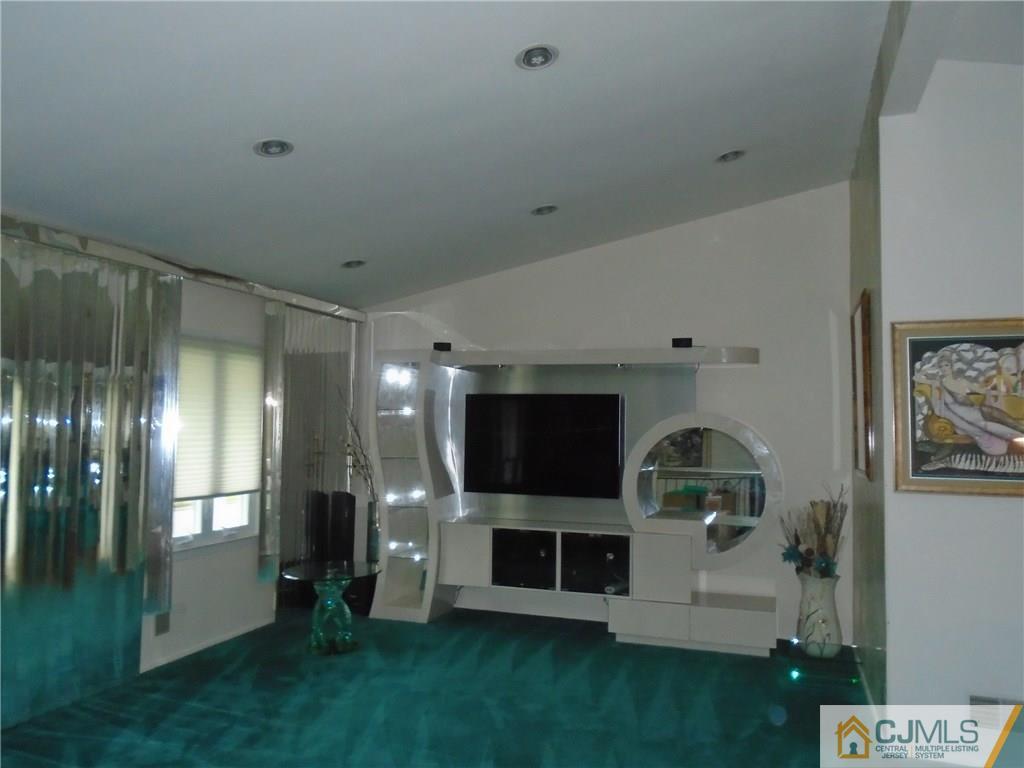 69 Harmon Road Edison, NJ 08837 - Photo 4 of 23 a living room with stainless steel appliances kitchen island furniture and a fireplace