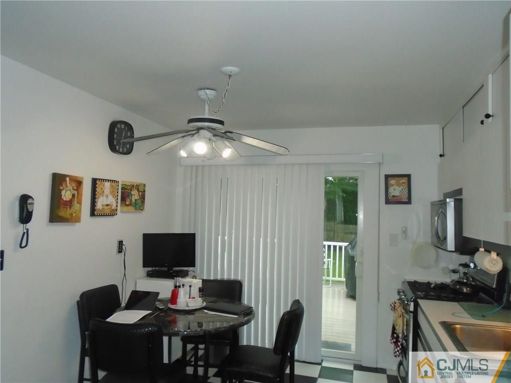 69 Harmon Road Edison, NJ 08837 - Photo 8 of 23 a view of a workspace with furniture and a flat screen tv