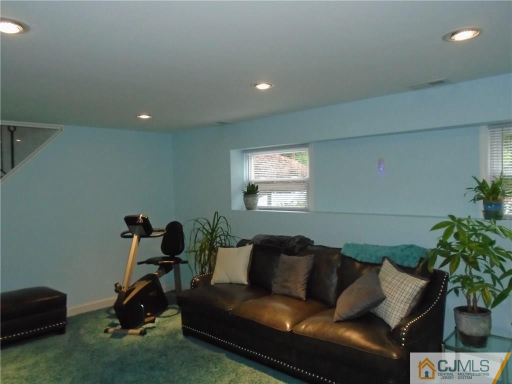 69 Harmon Road Edison, NJ 08837 - Photo 10 of 23 a living room with furniture a potted plant and a rug